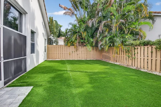 a view of an house with backyard and a garden