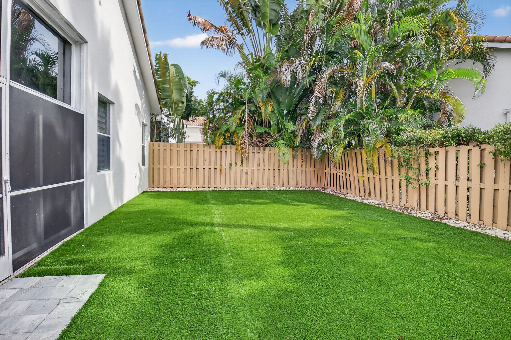 6668 Northwest 25th Terrace Boca Raton, FL 33496 - Photo 40 of 53 a view of backyard with wooden fence