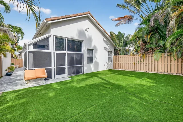 a living room with furniture a chandelier and a fireplace