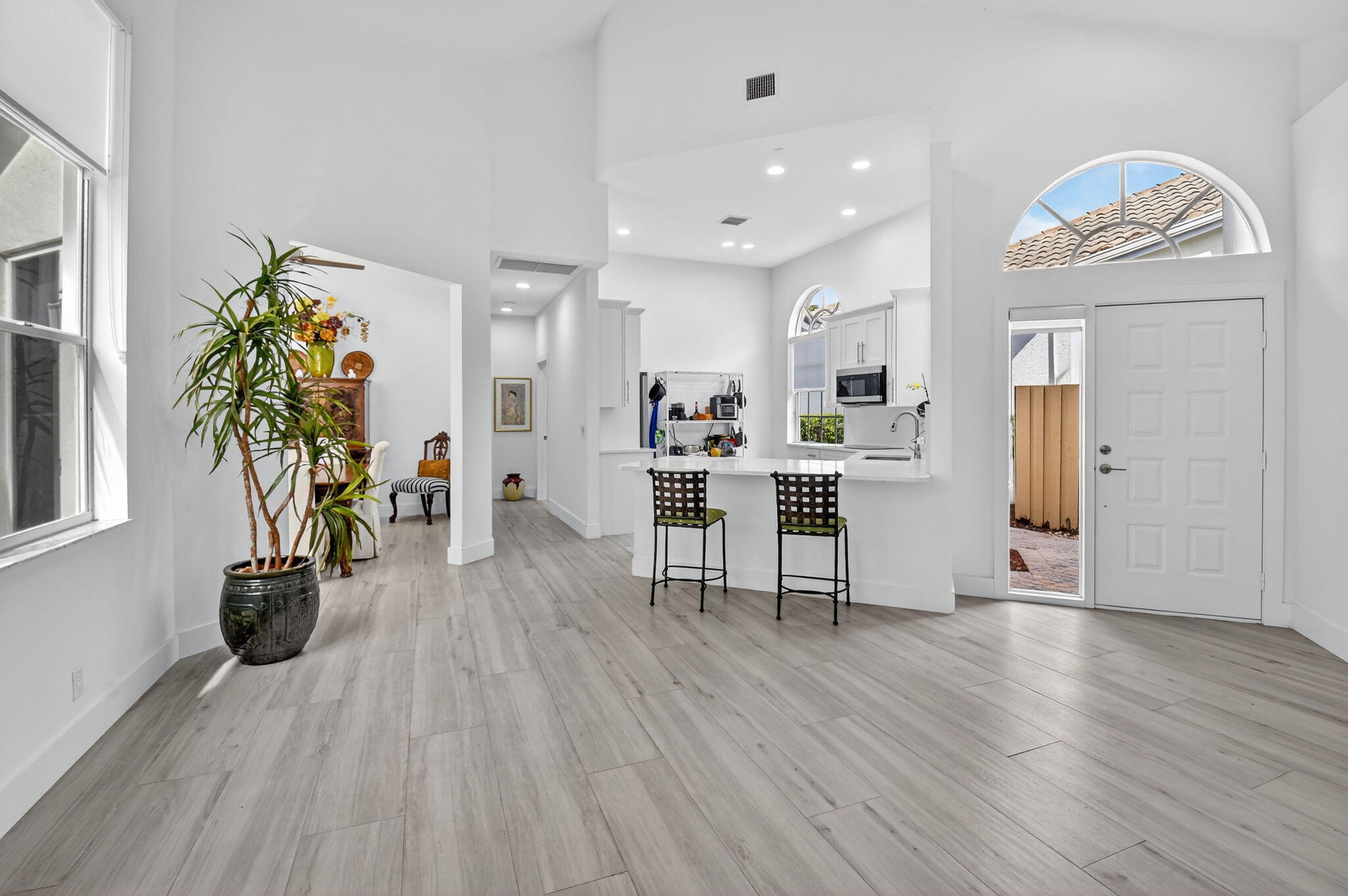 6668 Northwest 25th Terrace Boca Raton, FL 33496 - Photo 6 of 53 a living room with furniture and a wooden floor