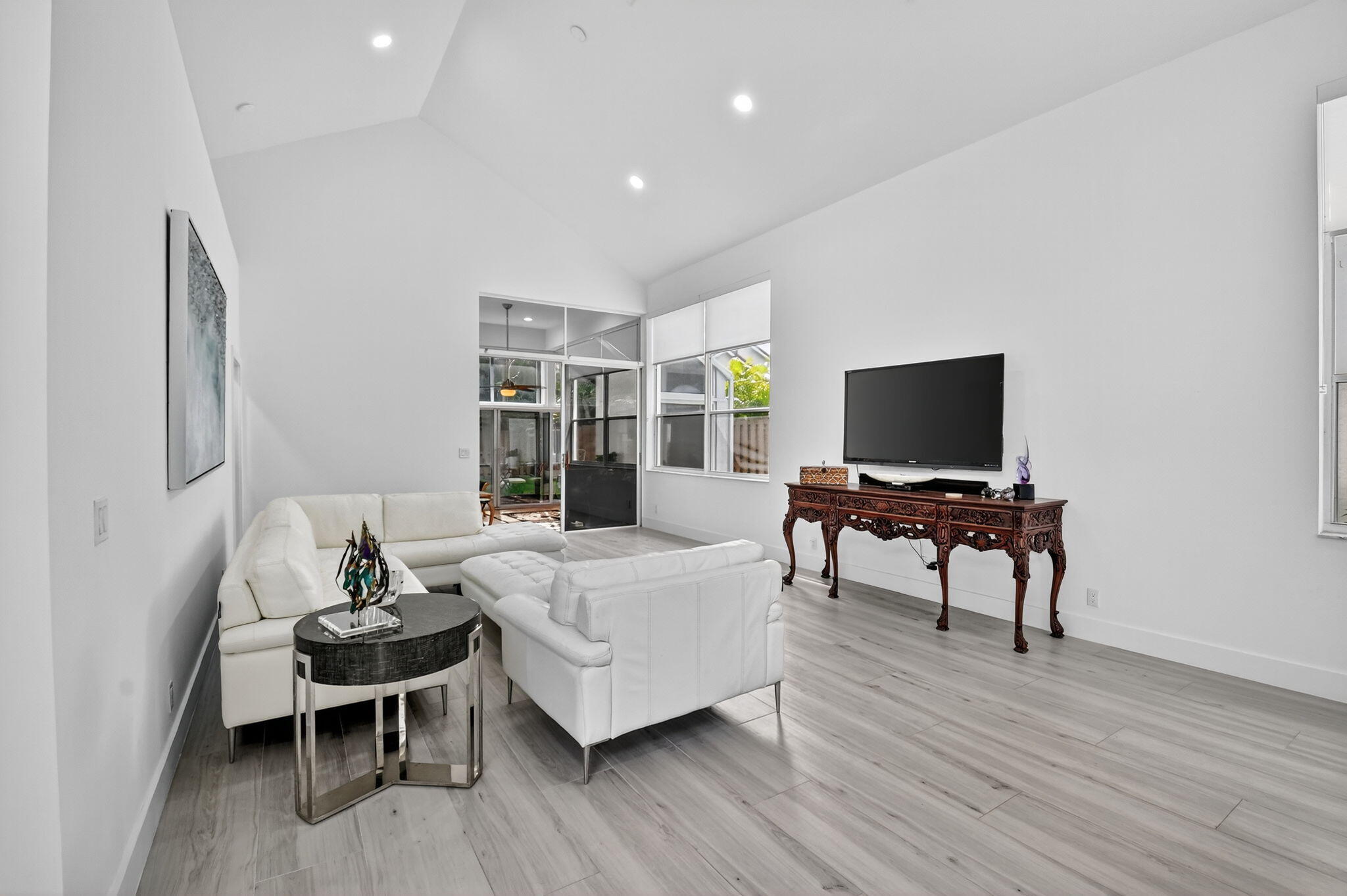 6668 Northwest 25th Terrace Boca Raton, FL 33496 - Photo 7 of 53 a living room with furniture and a flat screen tv