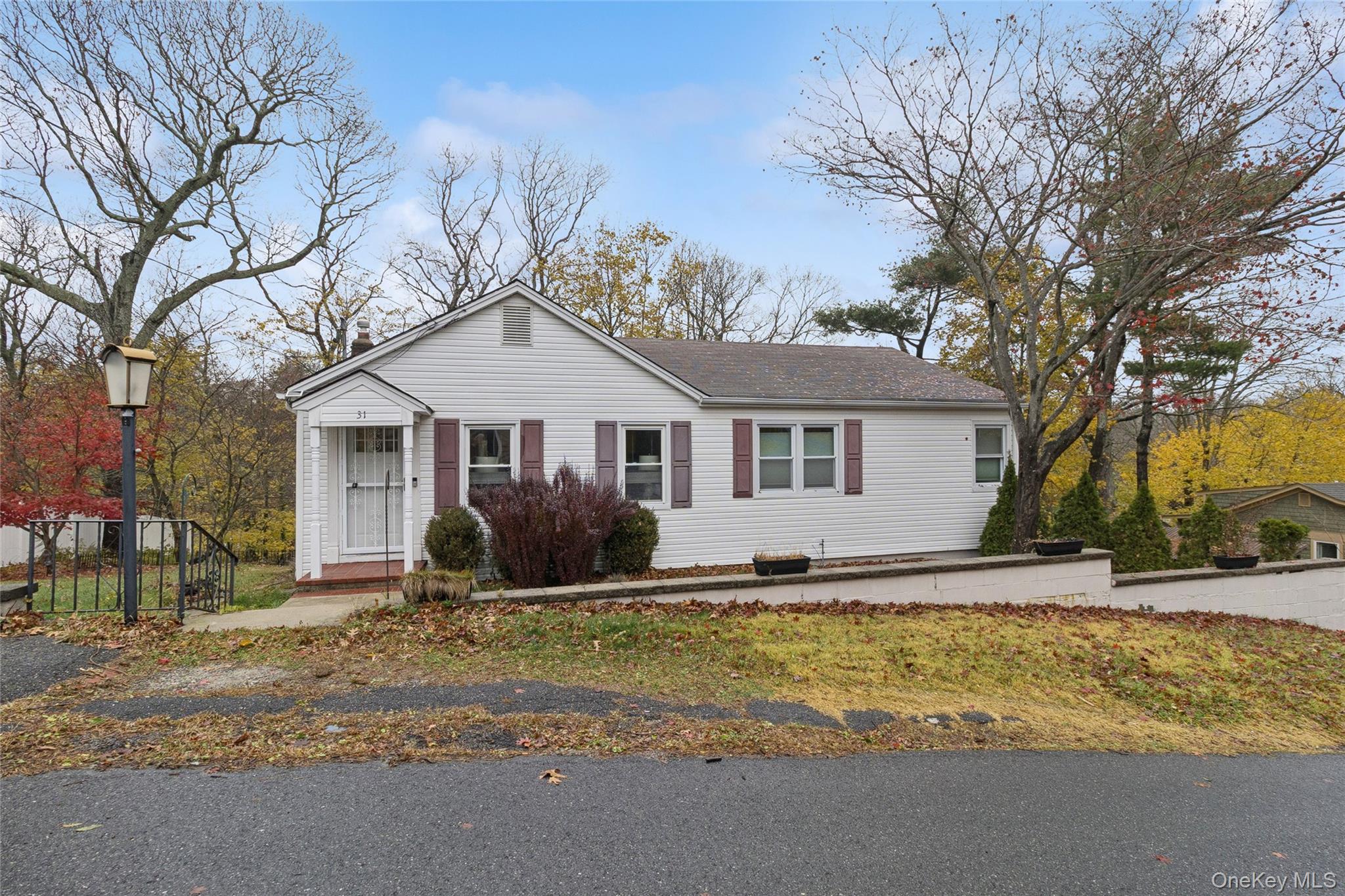 a front view of house with yard and trees