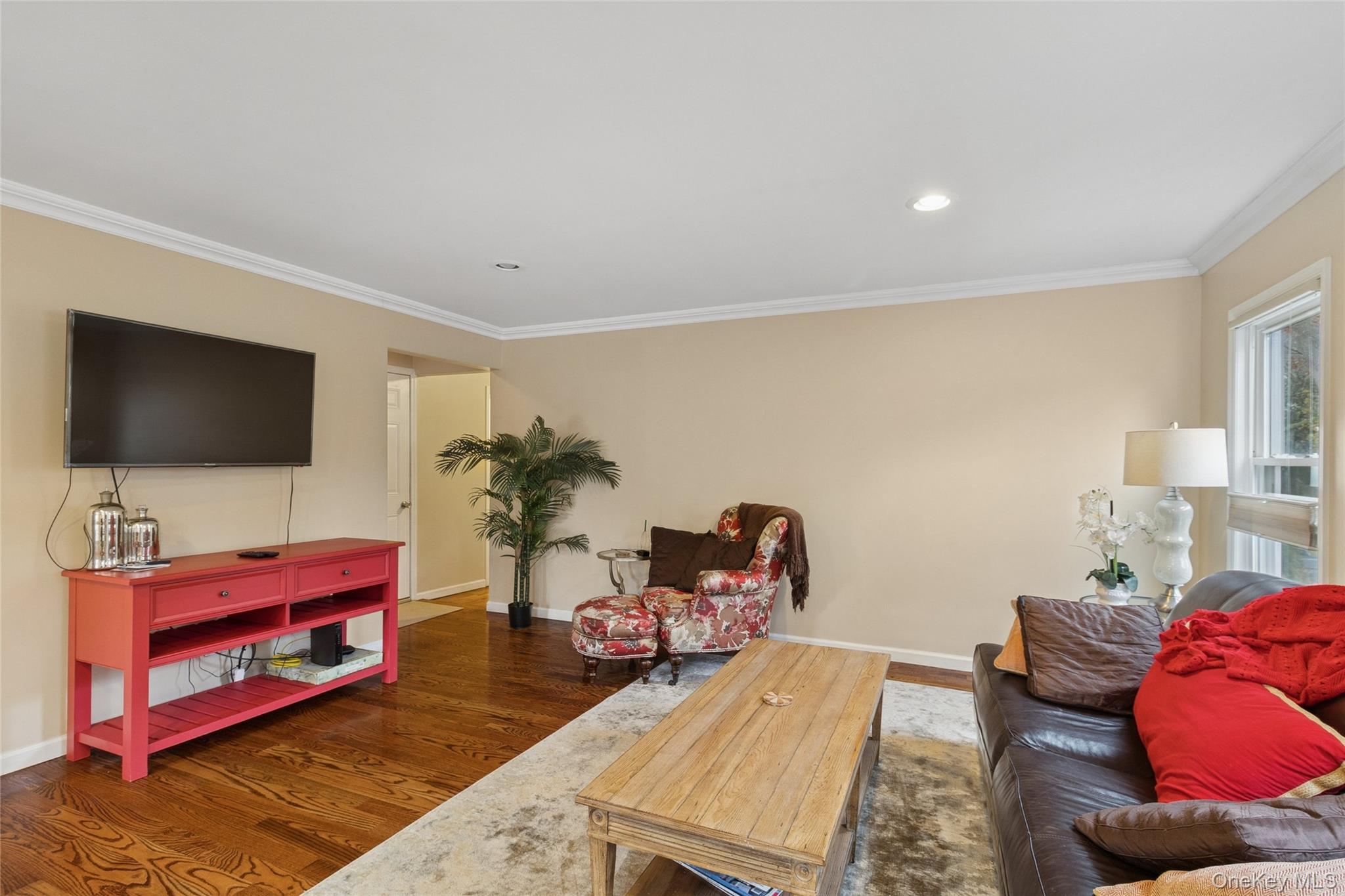 31 Amityville Road Sound Beach, NY 11789 - Photo 16 of 33 a living room with furniture and a flat screen tv