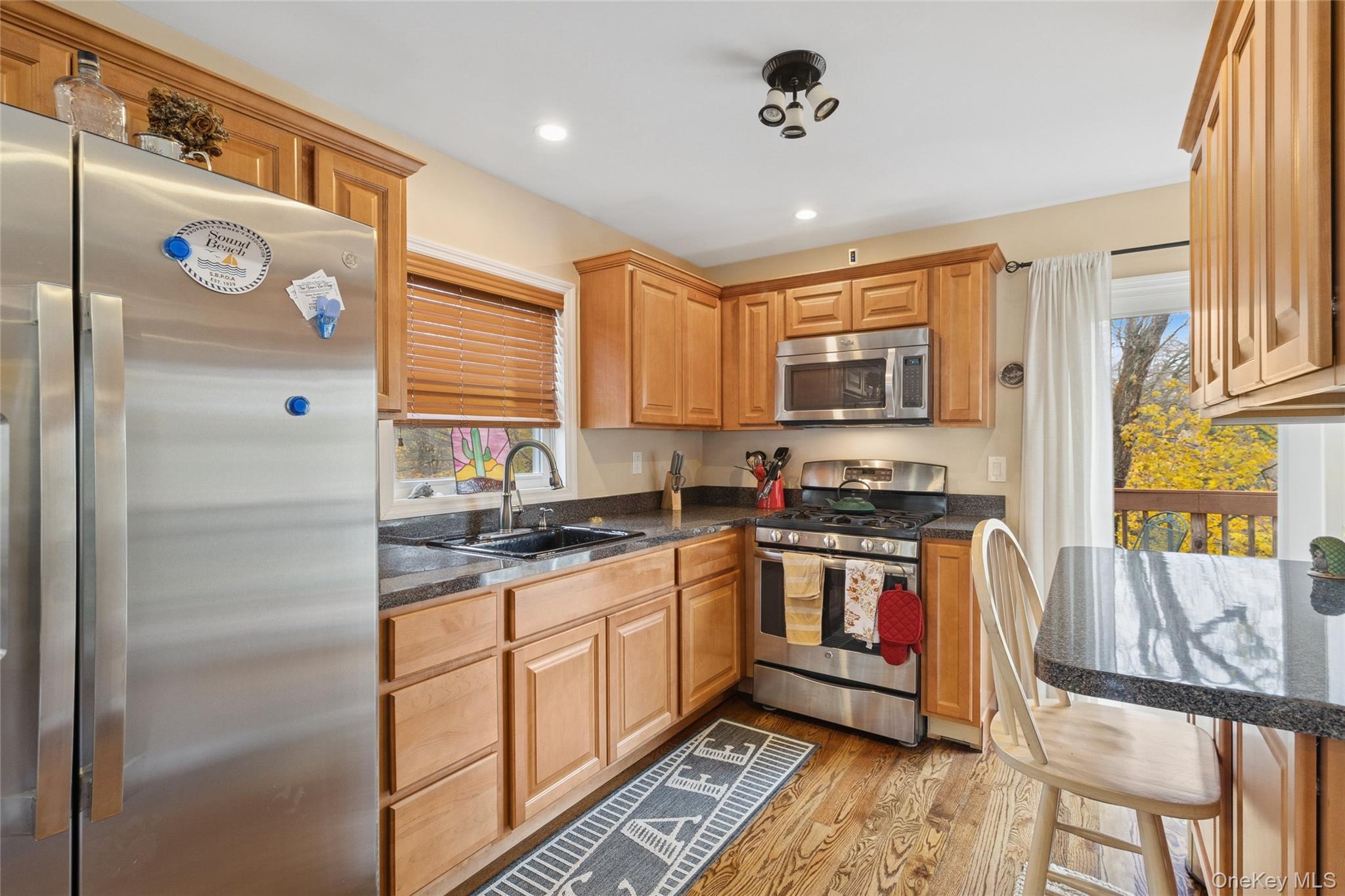 31 Amityville Road Sound Beach, NY 11789 - Photo 20 of 33 a kitchen with stainless steel appliances granite countertop a stove and a refrigerator