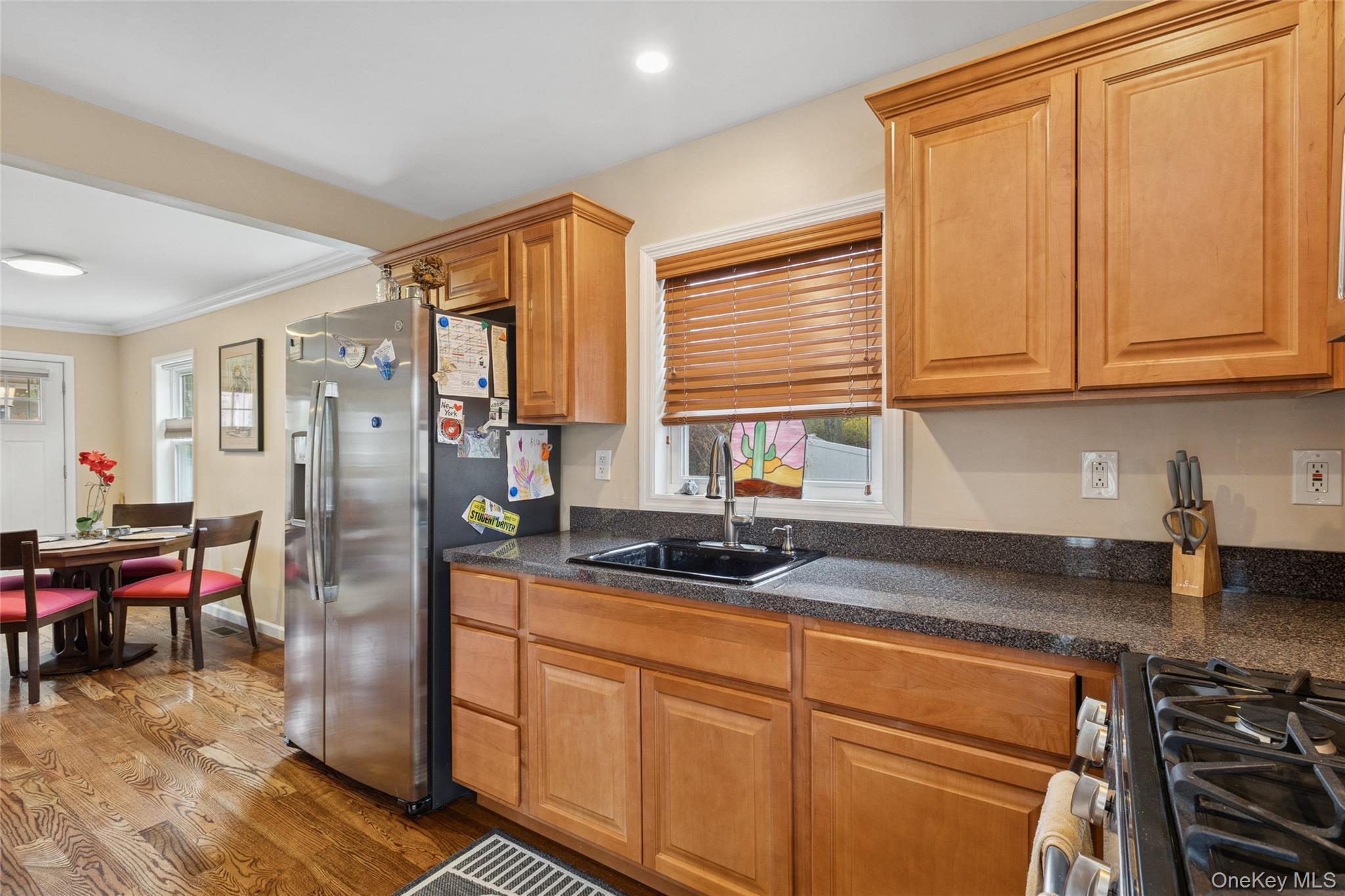 31 Amityville Road Sound Beach, NY 11789 - Photo 23 of 33 a kitchen with stainless steel appliances granite countertop a refrigerator and a sink
