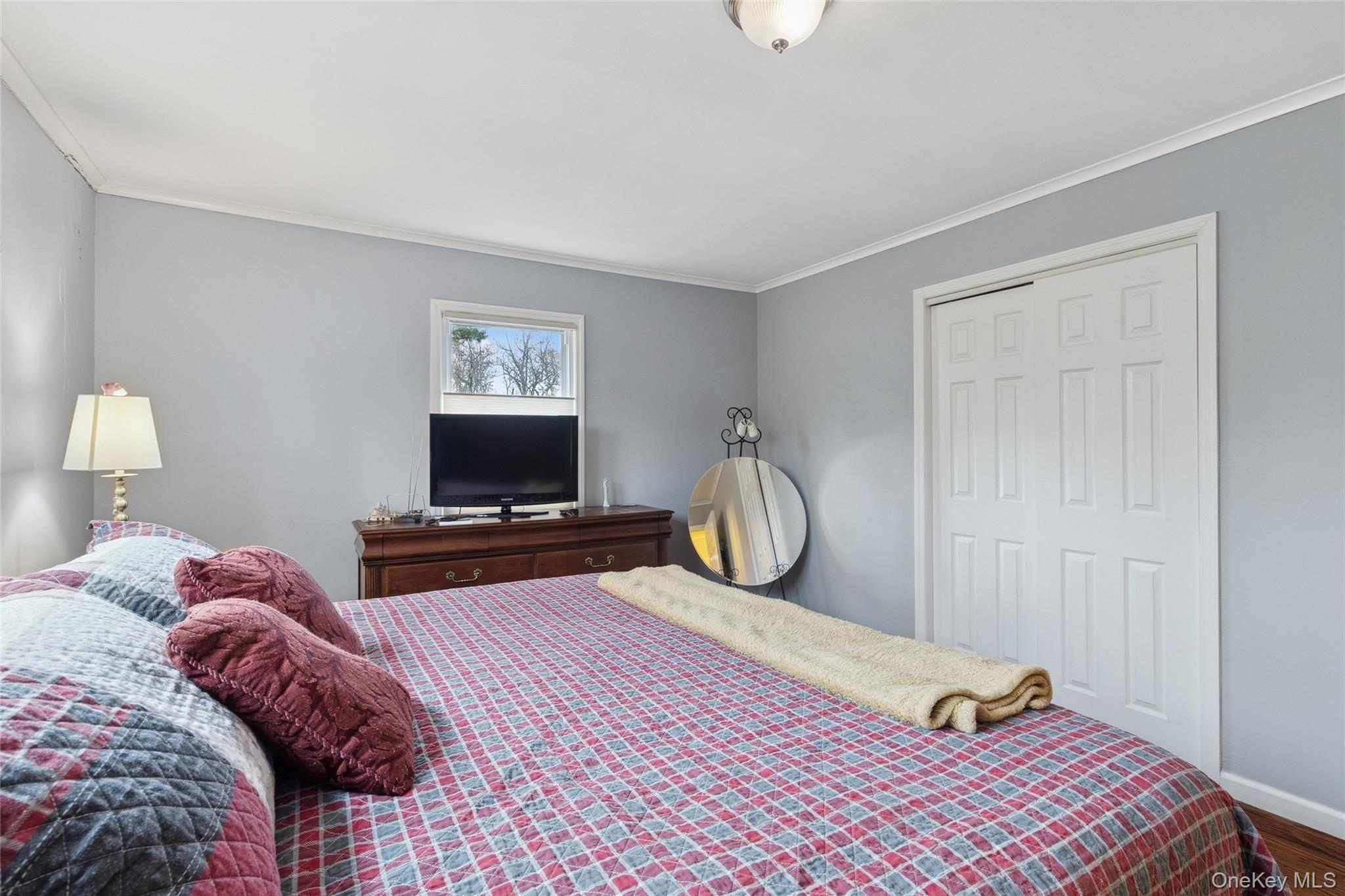 31 Amityville Road Sound Beach, NY 11789 - Photo 27 of 33 a bedroom with a bed and wooden floor