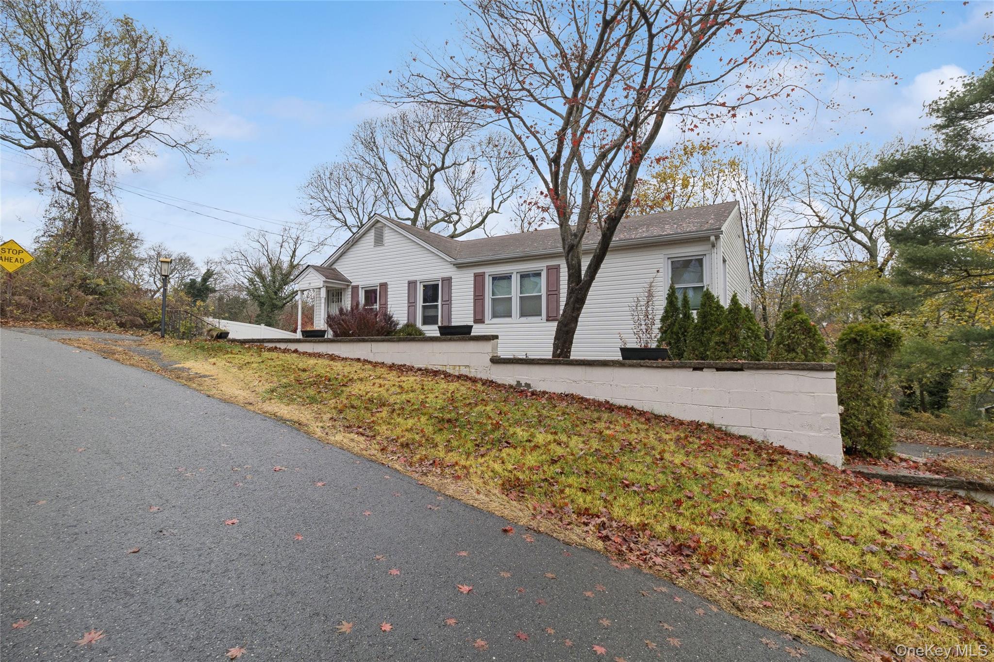 31 Amityville Road Sound Beach, NY 11789 - Photo 3 of 33 a front view of a house with a yard and trees