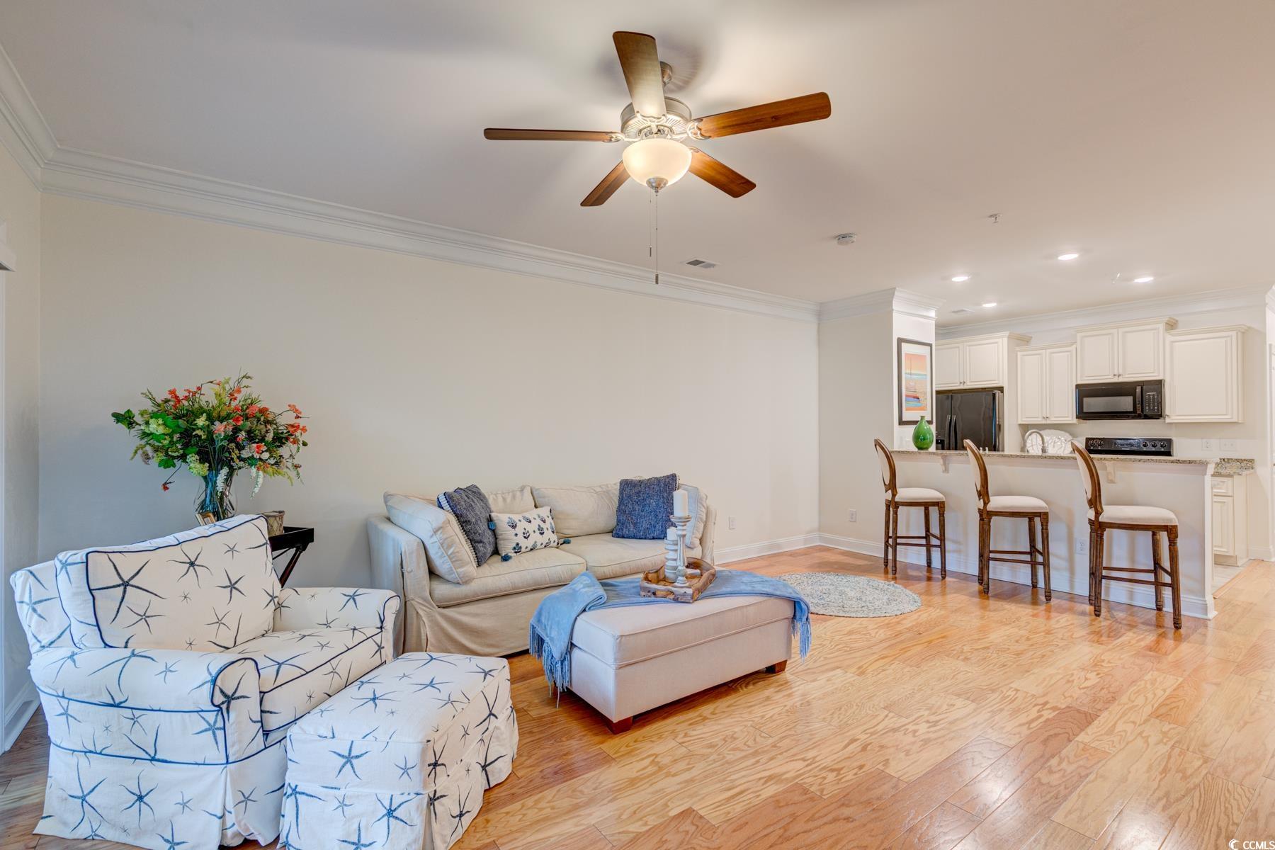 130 Puffin Drive, Unit 2B Pawleys Island, SC 29585 - Photo 16 of 34 Living area featuring ornamental molding, light wood-style floors, a ceiling fan, and recessed lighting