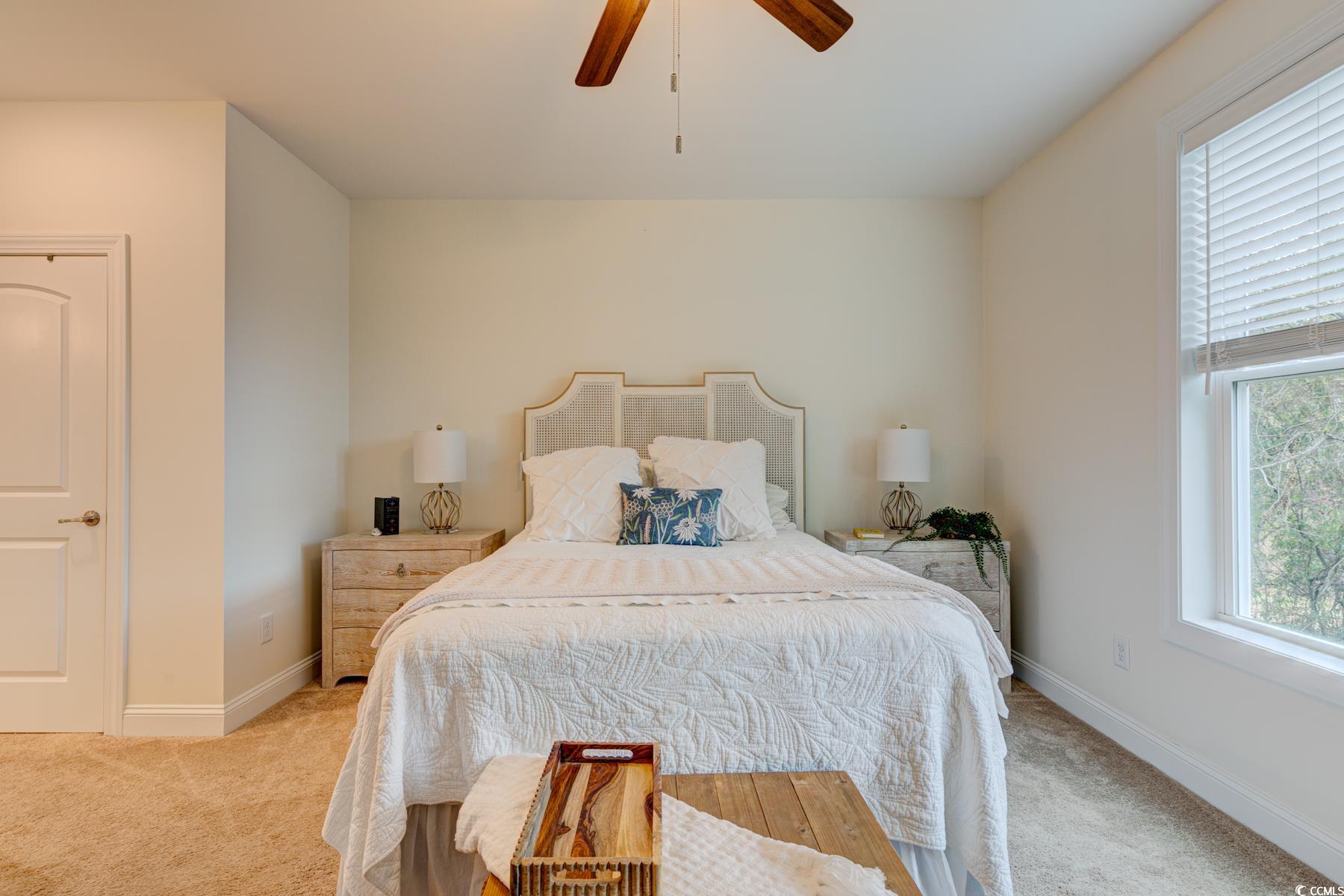 130 Puffin Drive, Unit 2B Pawleys Island, SC 29585 - Photo 21 of 34 Bedroom featuring carpet flooring and a ceiling fan