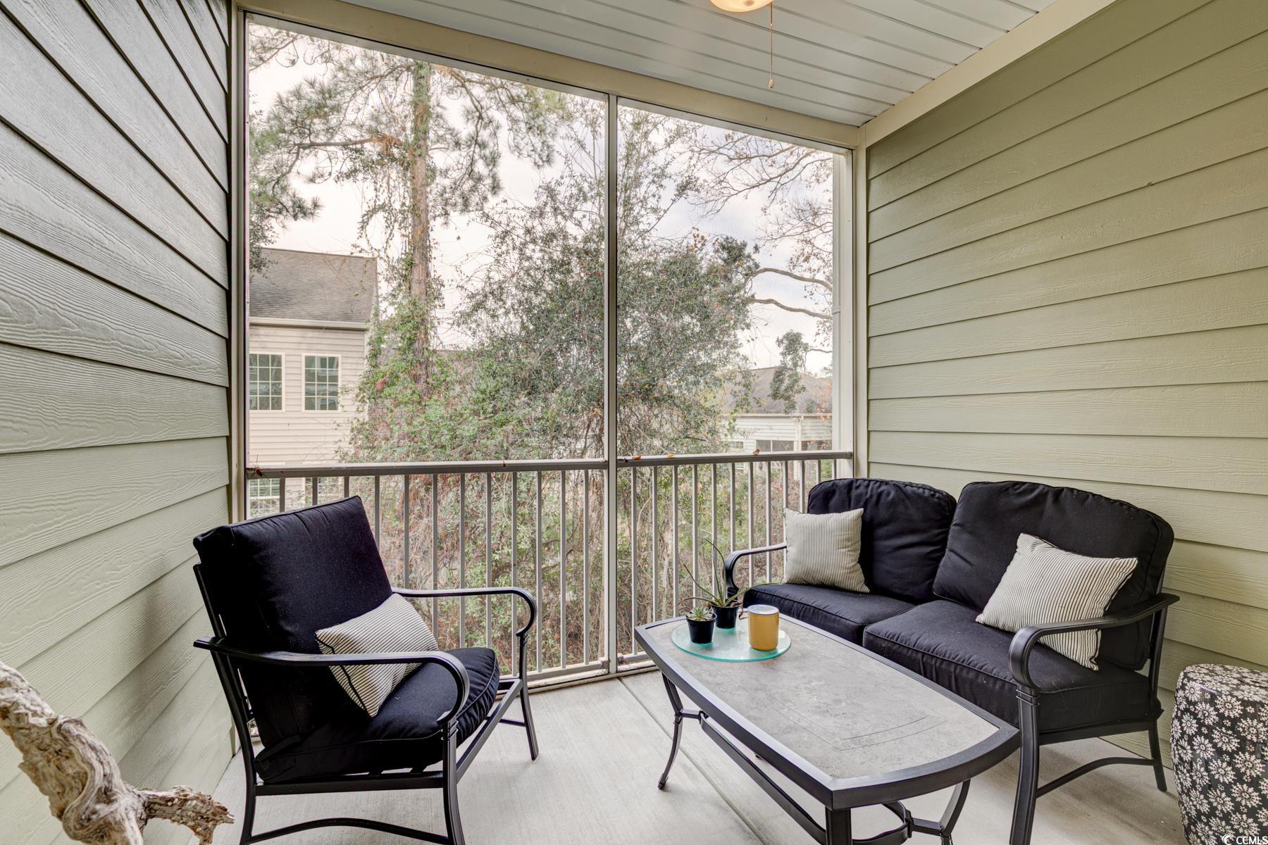 130 Puffin Drive, Unit 2B Pawleys Island, SC 29585 - Photo 28 of 34 Sunroom with a balcony and outdoor lounge area