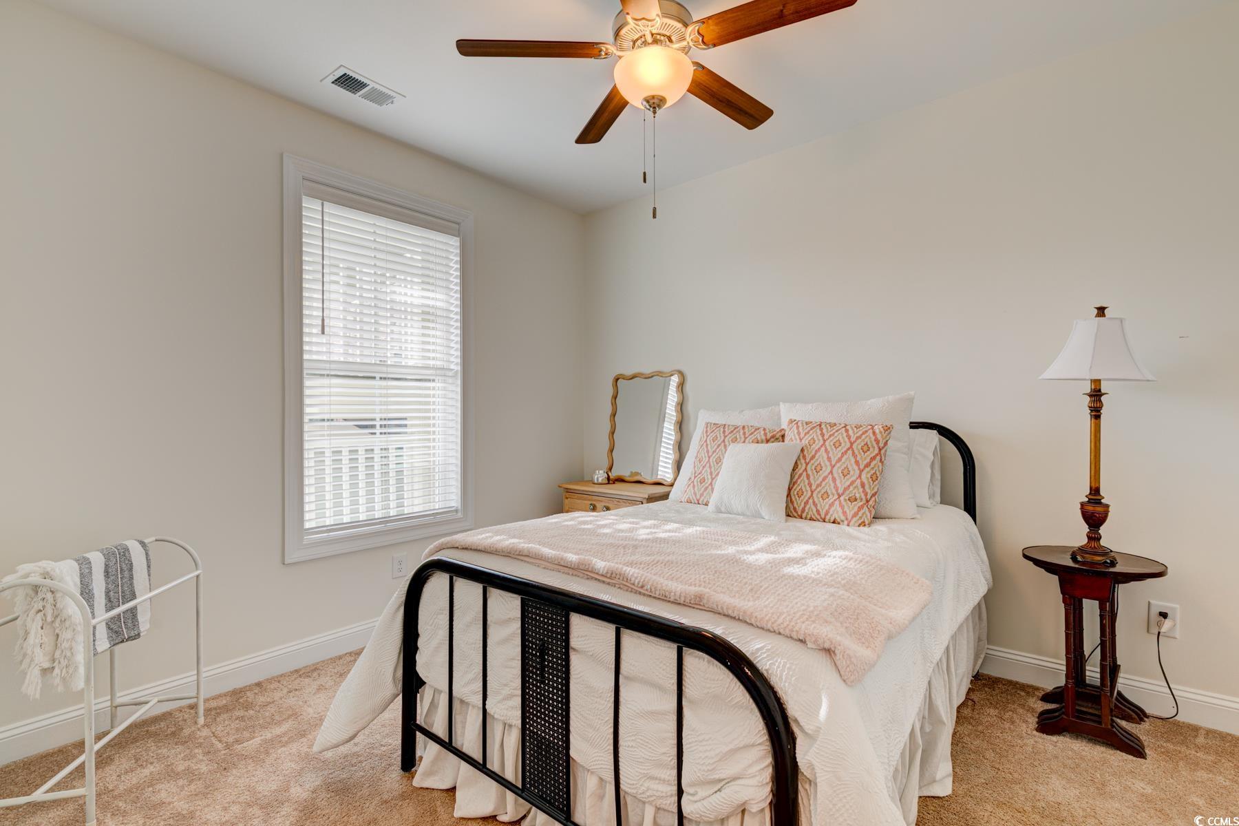 130 Puffin Drive, Unit 2B Pawleys Island, SC 29585 - Photo 4 of 34 Bedroom with light colored carpet and ceiling fan