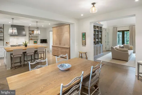 a spacious bedroom with a bed a couch and a chandelier