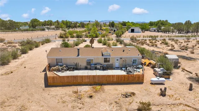 an aerial view of ocean and residential houses with outdoor space