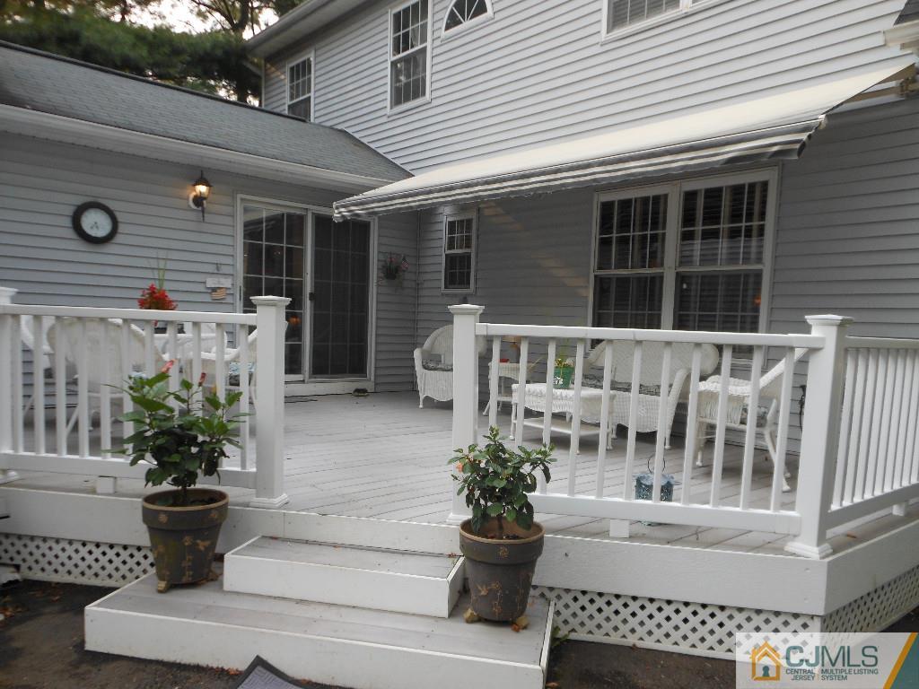 421 Ridge Road Dayton, NJ 08810 - Photo 14 of 17 a front view of a house with porch and furniture