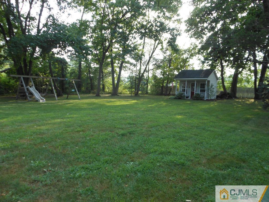 421 Ridge Road Dayton, NJ 08810 - Photo 16 of 17 a view of a backyard with large trees