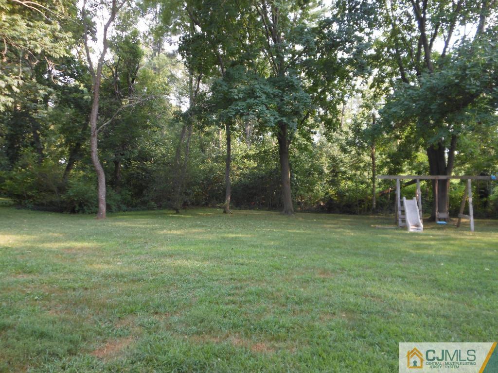421 Ridge Road Dayton, NJ 08810 - Photo 17 of 17 a backyard of a house with lots of green space