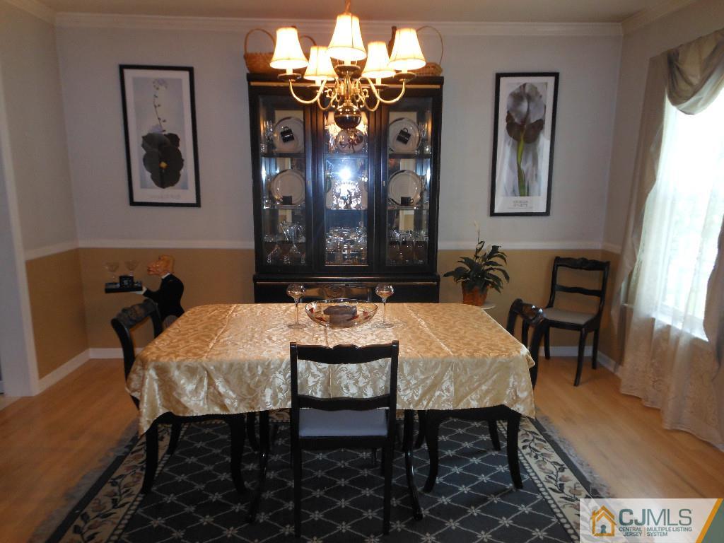 421 Ridge Road Dayton, NJ 08810 - Photo 6 of 17 a view of a dining room with furniture and chandelier