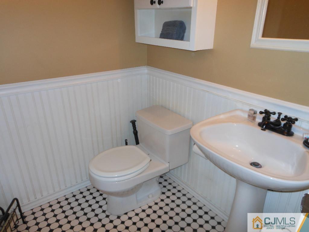 421 Ridge Road Dayton, NJ 08810 - Photo 7 of 17 a white toilet sitting next to a white sink and vanity