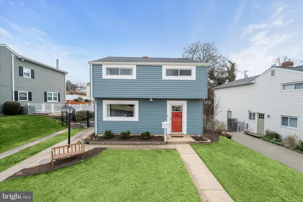 a front view of house with yard and outdoor seating