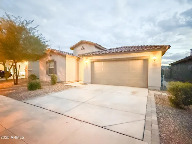 a front view of a house with a yard and garage