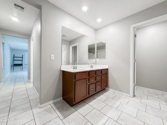 a bathroom with a sink vanity and mirror