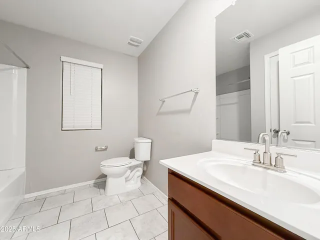 a bathroom with a sink toilet and vanity