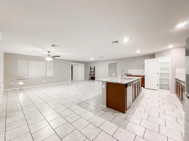 a large white kitchen with a stove a sink and a refrigerator