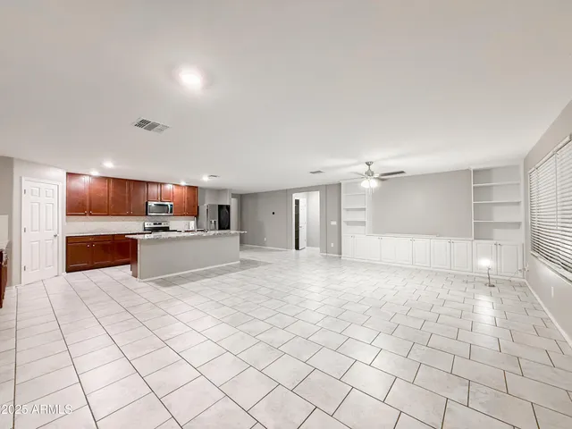 a view of kitchen with granite countertop cabinets
