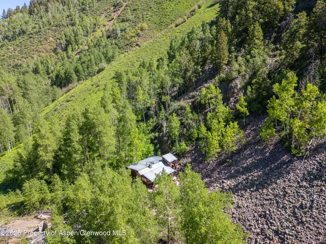 an aerial view of a house with a yard