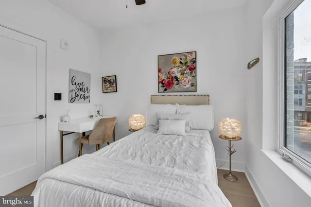 a bedroom with a large bed and a chandelier