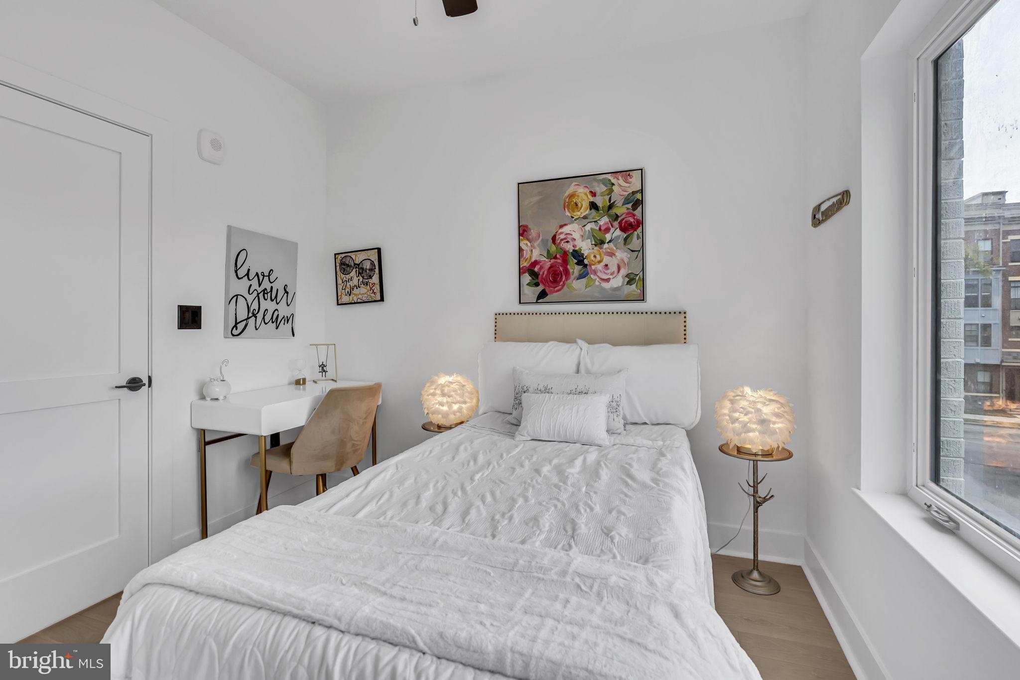 1103 Fern Street Northwest, Unit 301 Washington, DC 20012 - Photo 16 of 57 a bedroom with a bed and a painting on the wall