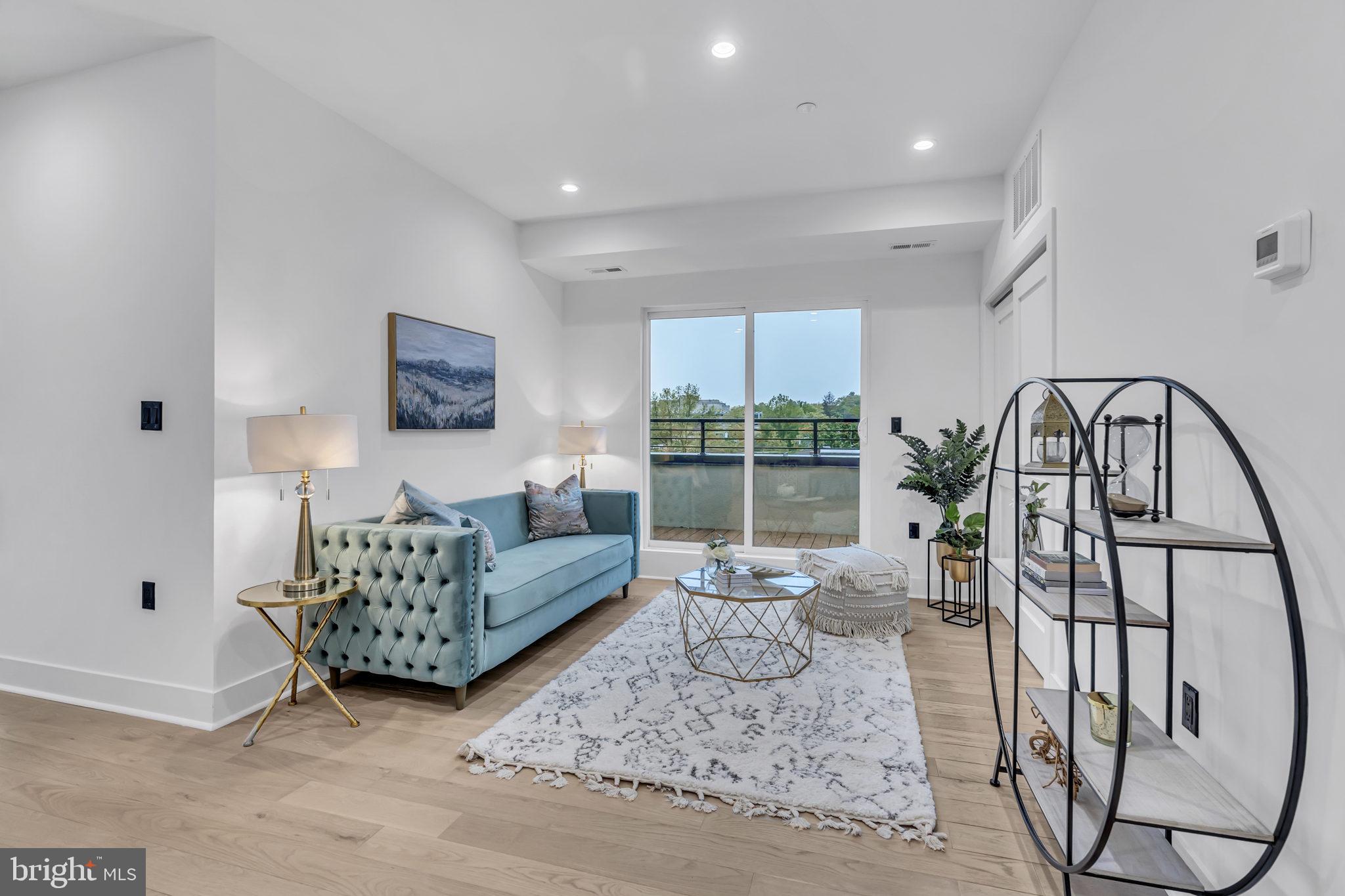 1103 Fern Street Northwest, Unit 301 Washington, DC 20012 - Photo 28 of 57 a living room with furniture and a large window