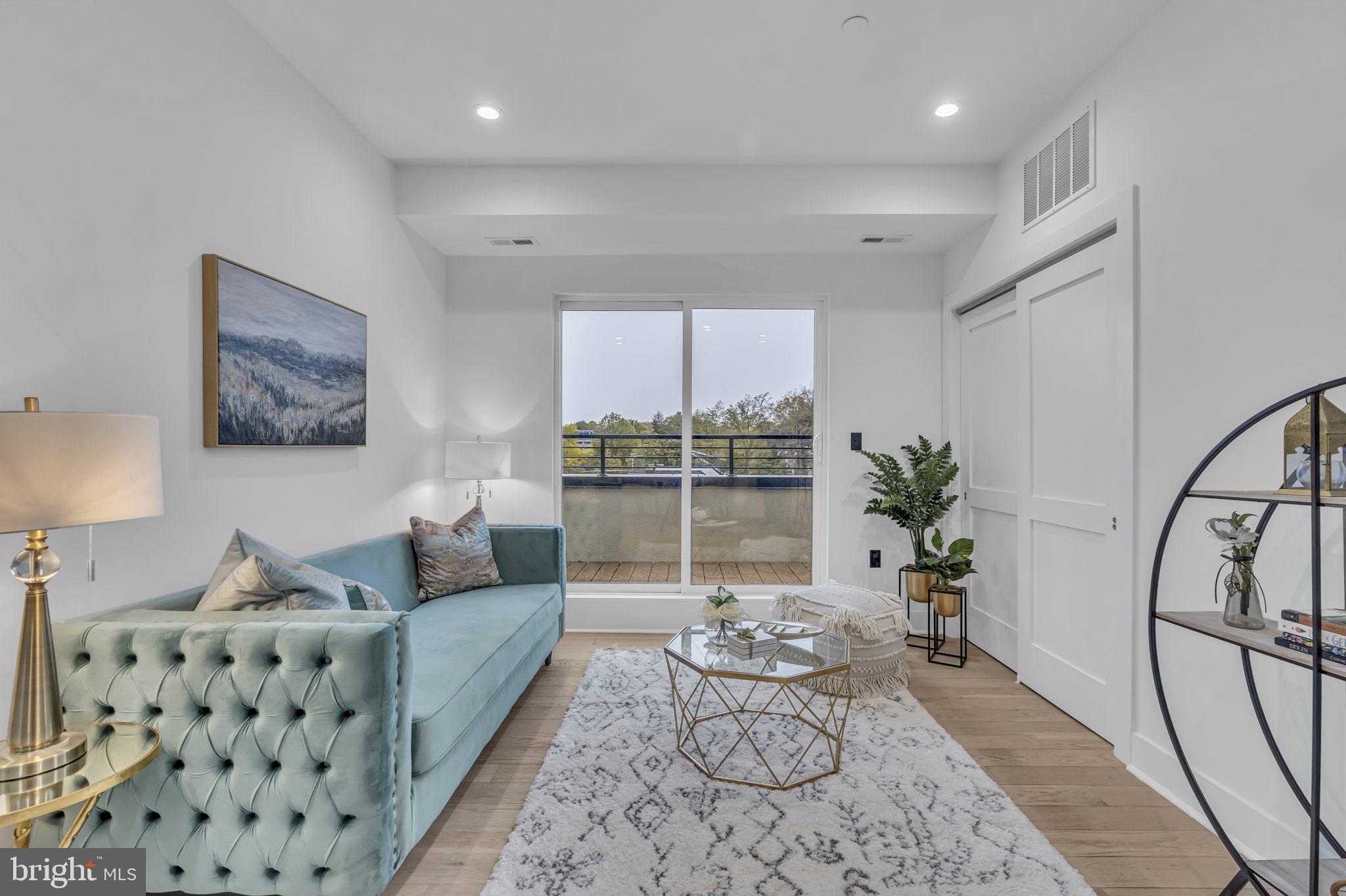 1103 Fern Street Northwest, Unit 301 Washington, DC 20012 - Photo 29 of 57 a living room with furniture and a large window