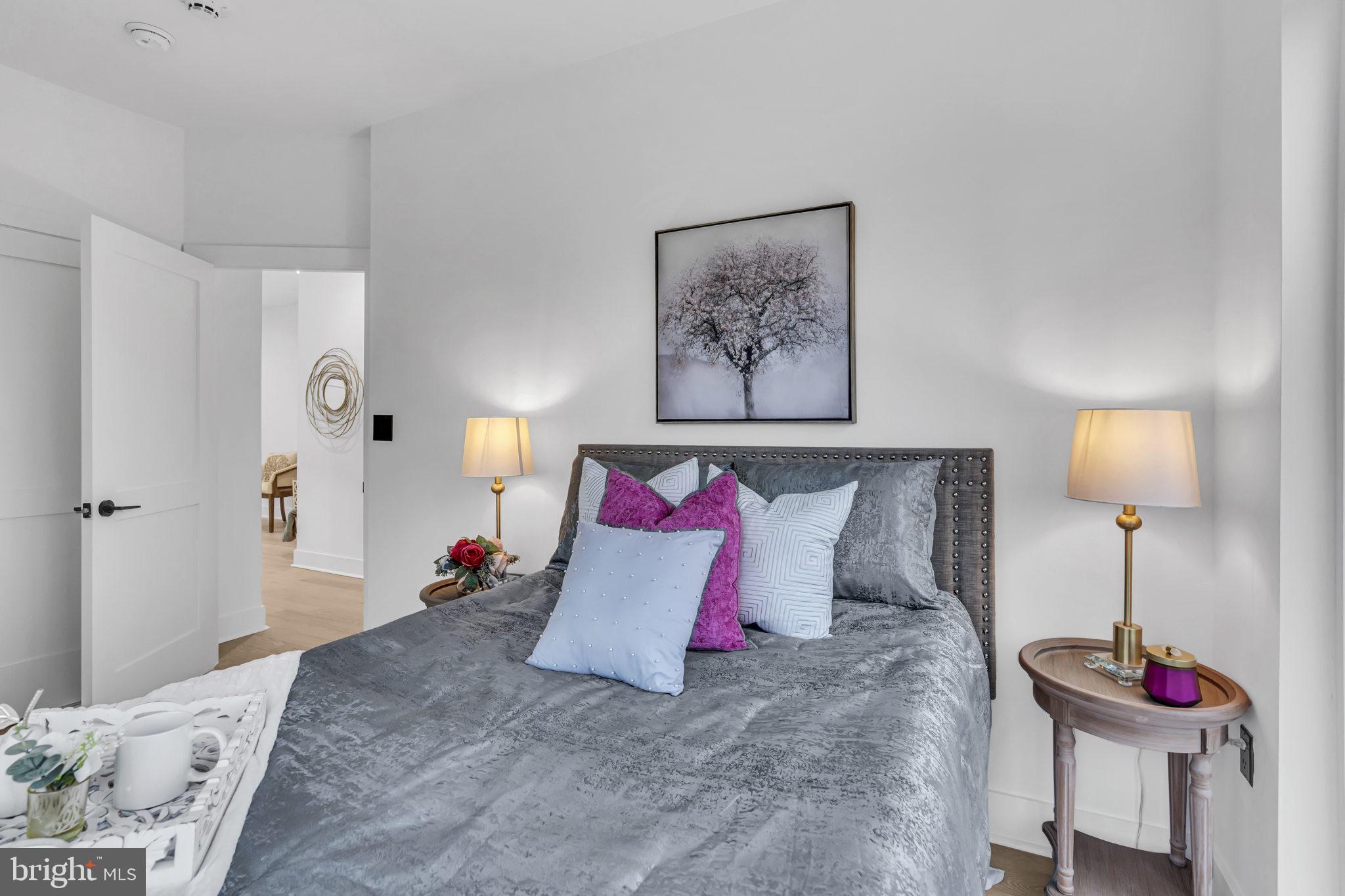 1103 Fern Street Northwest, Unit 301 Washington, DC 20012 - Photo 36 of 57 a bedroom with a bed and a lamp