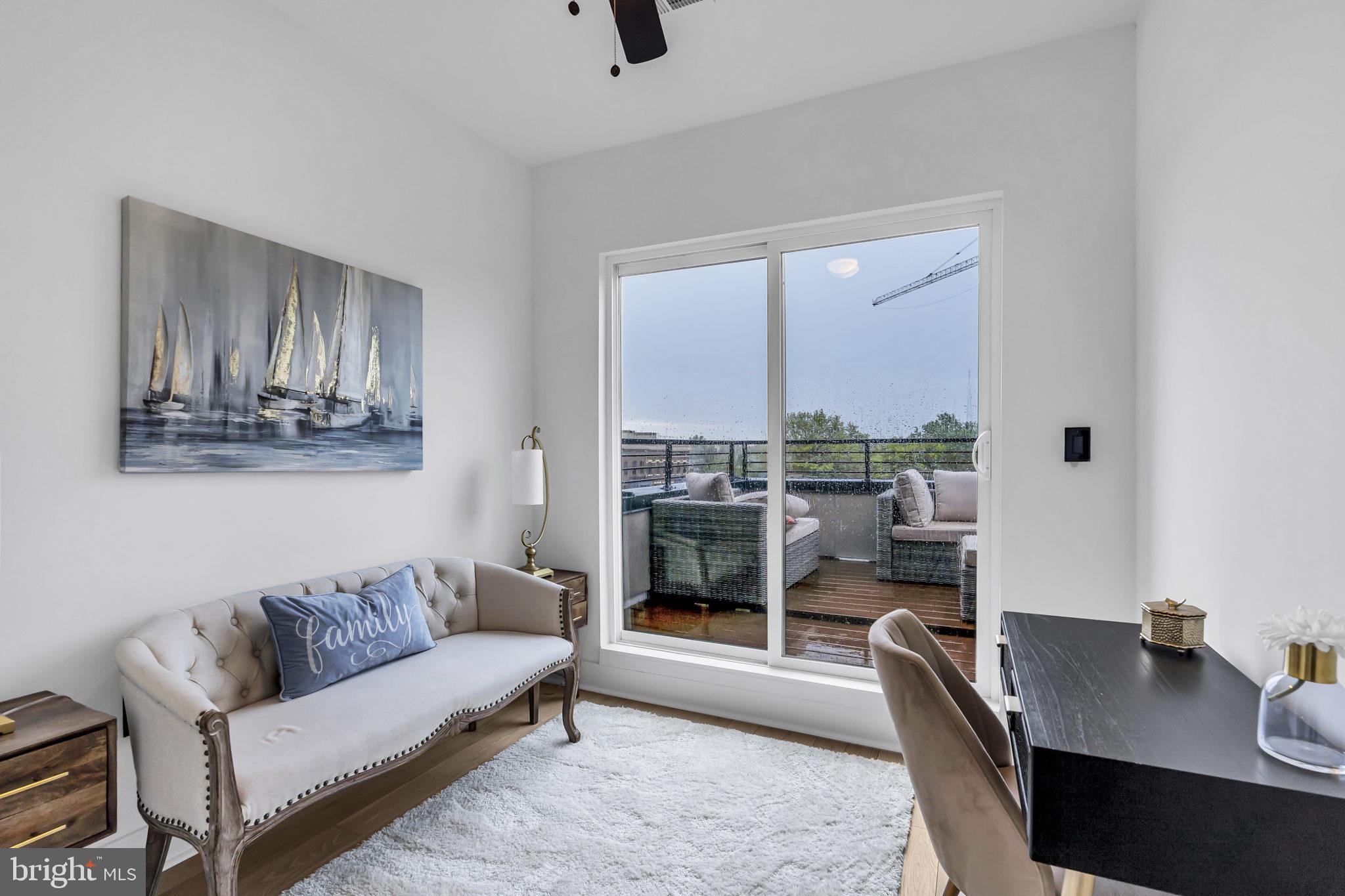 1103 Fern Street Northwest, Unit 301 Washington, DC 20012 - Photo 39 of 57 a living room with furniture and a table
