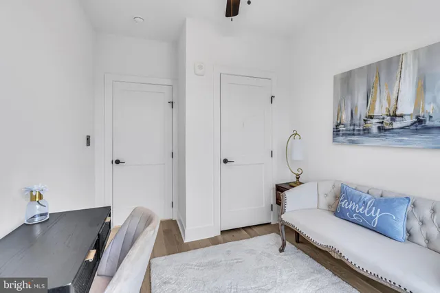 a view of a hallway with wooden floor and door