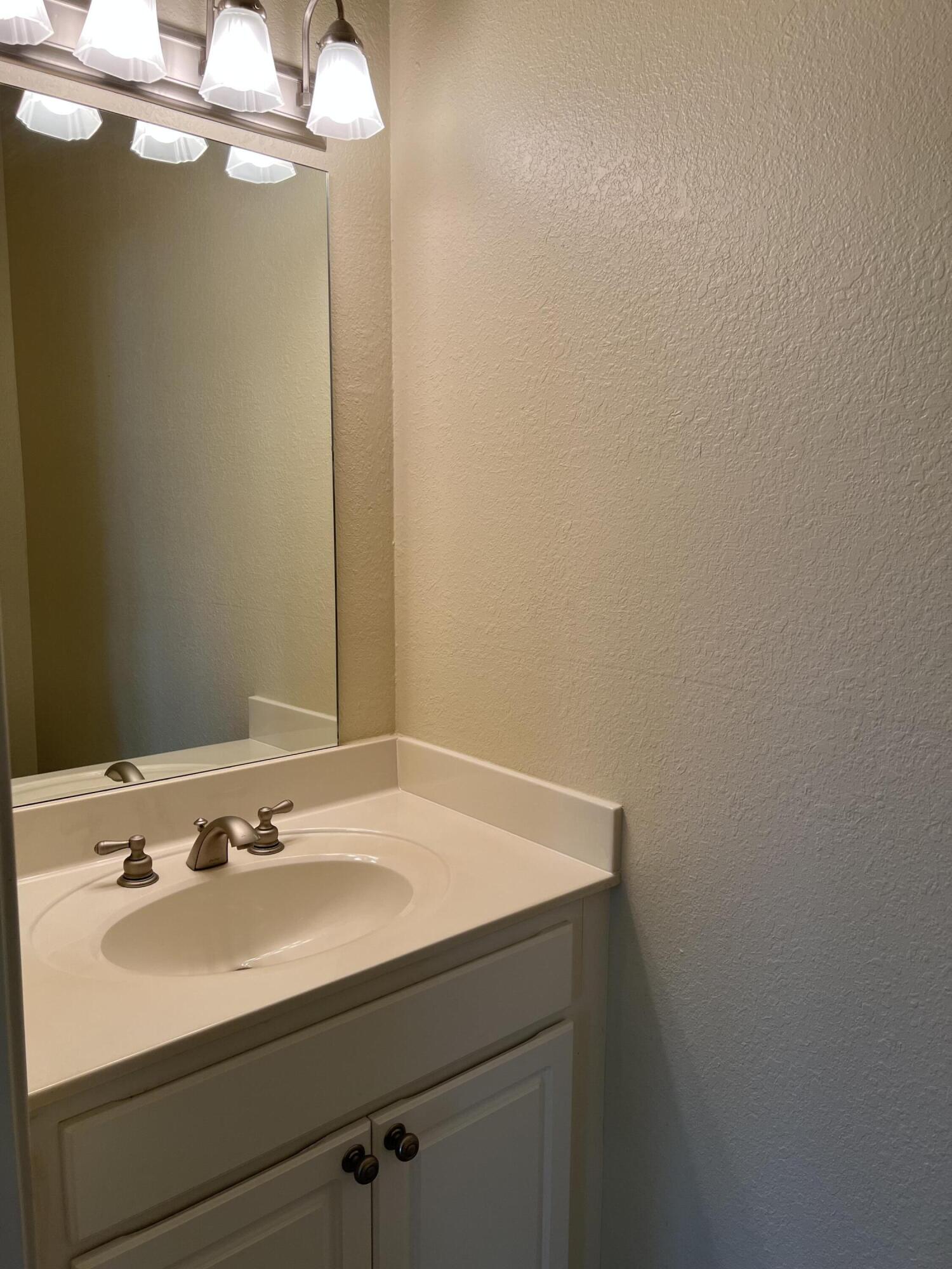 118 Spires Lane, Unit 5B Santa Rosa Beach, FL 32459 - Photo 14 of 28 a bathroom with a sink and a mirror