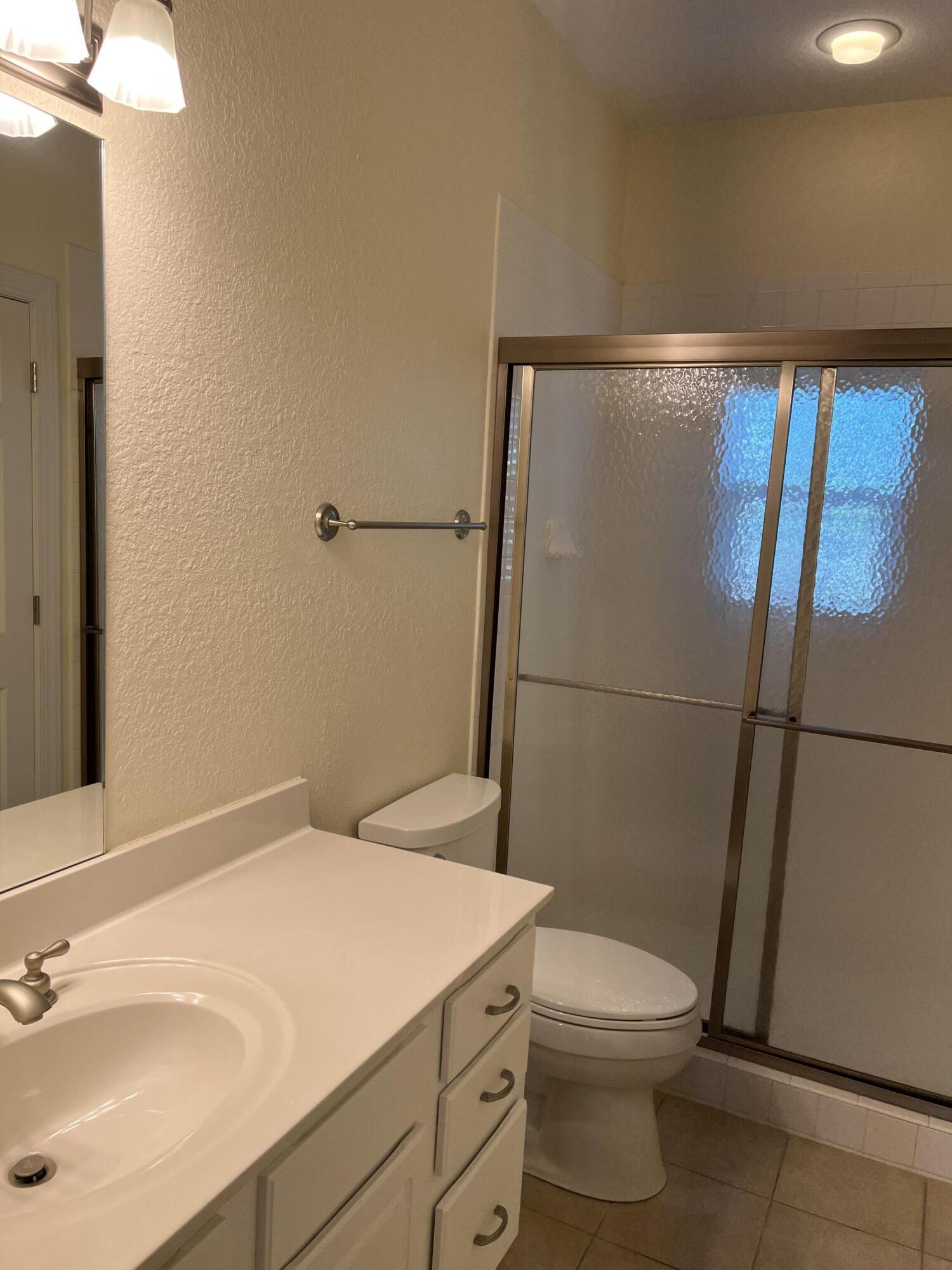 118 Spires Lane, Unit 5B Santa Rosa Beach, FL 32459 - Photo 25 of 28 a bathroom with a sink a toilet a shower and a mirror