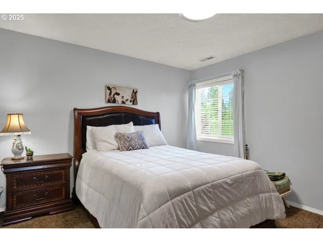 a bedroom with a bed and a tv