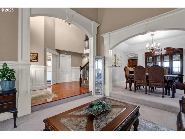 a living room with furniture and a dining table