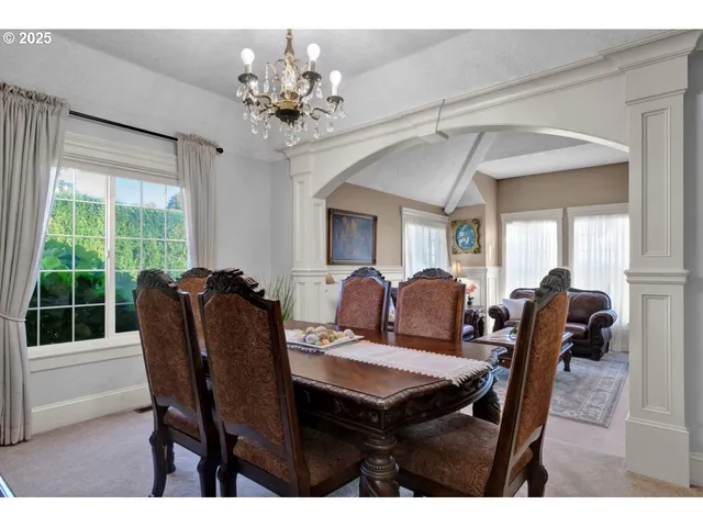 a view of a dining room with furniture and chandelier