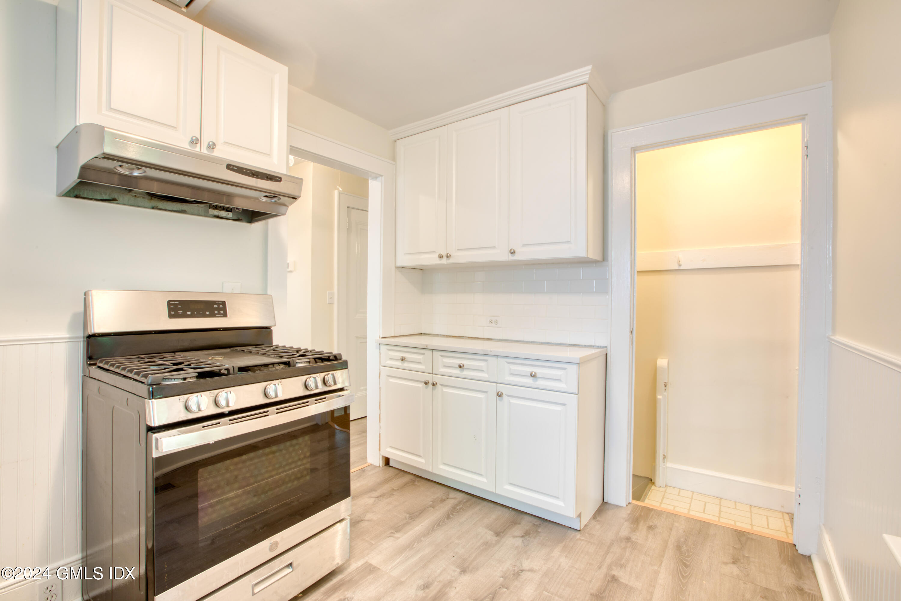 4 R Highview Avenue Old Greenwich, CT 06870 - Photo 11 of 21 a kitchen with white cabinets and white appliances