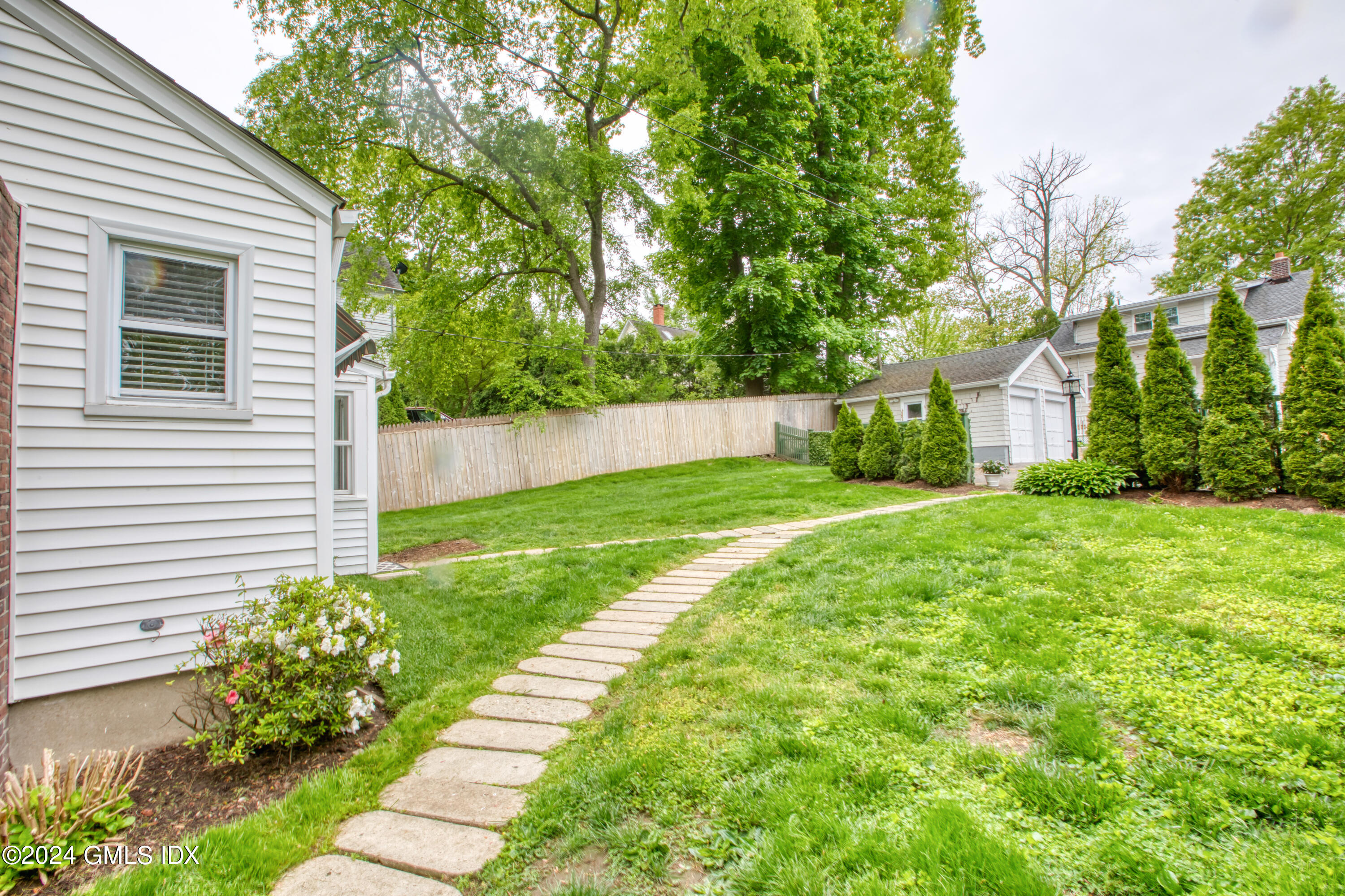 4 R Highview Avenue Old Greenwich, CT 06870 - Photo 4 of 21 a view of a house with a yard and flower garden
