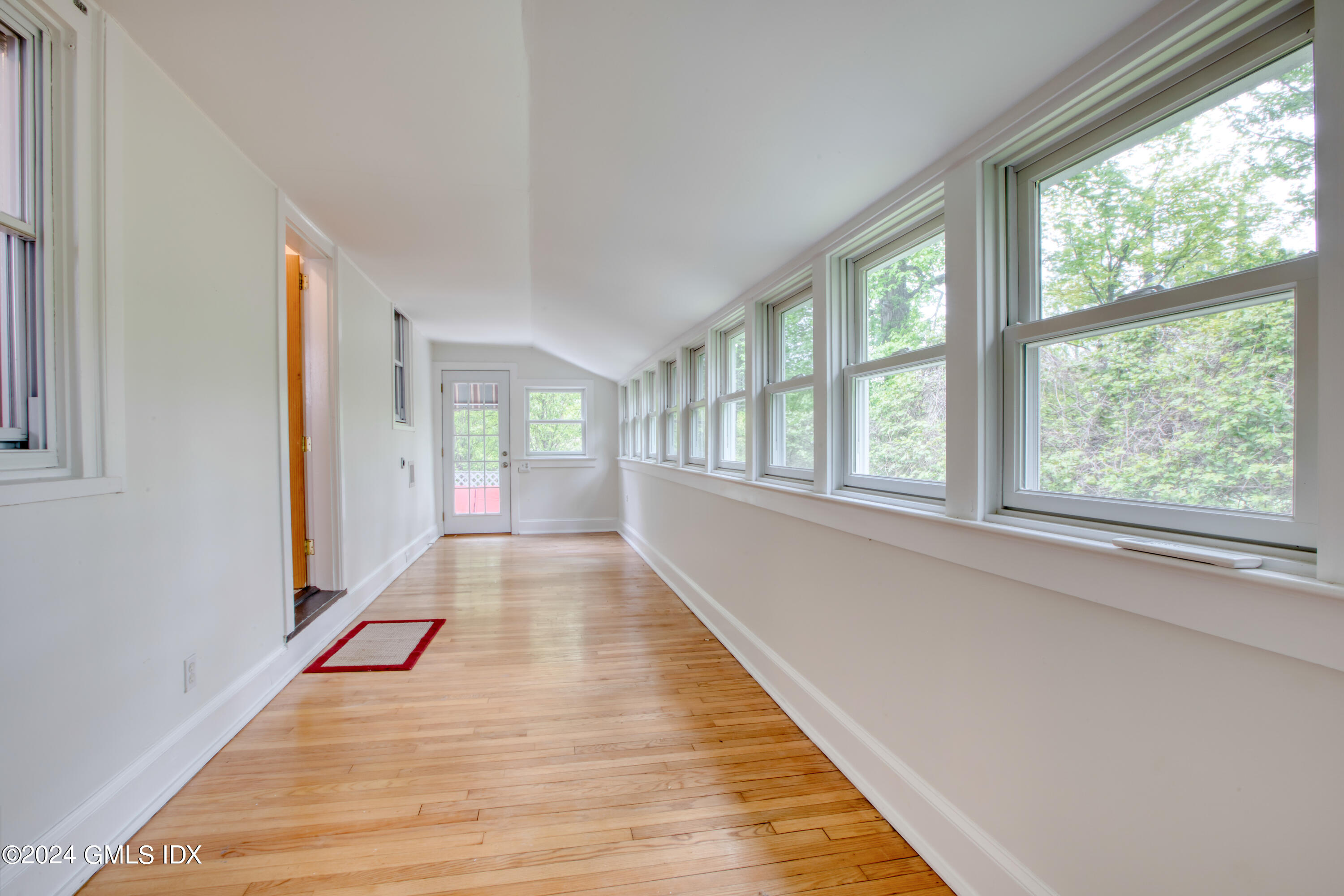 4 R Highview Avenue Old Greenwich, CT 06870 - Photo 8 of 21 a view of an empty room with wooden floor and a window