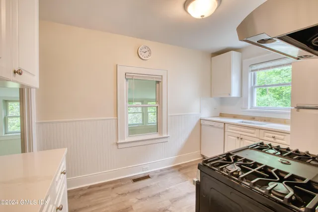a kitchen with a stove and a window