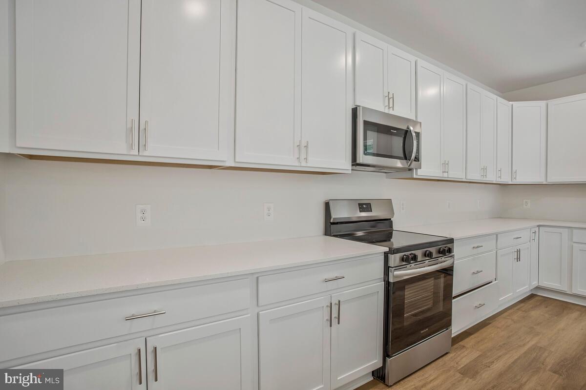 721 Nollmeyer Road Middle River, MD 21220 - Photo 14 of 33 a kitchen with granite countertop white cabinets and stainless steel appliances