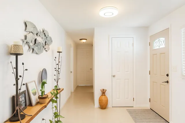a view of a room with mirror and window