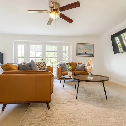 a living room with furniture rug and window
