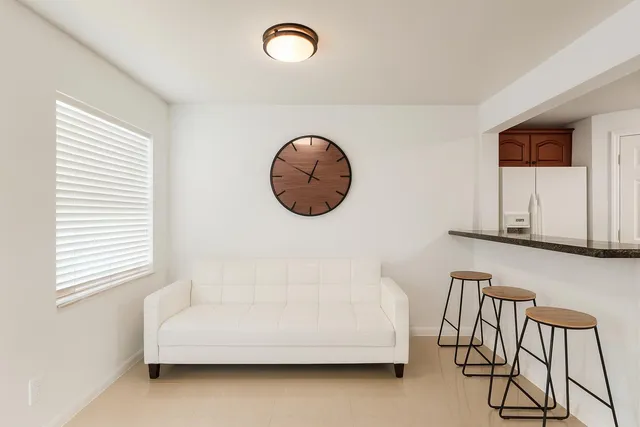 a bathroom with a white tub and a chair