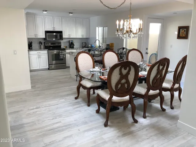 a view of a dining room with furniture and chandelier